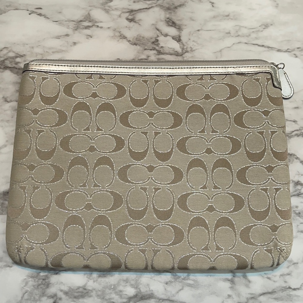 Khaki Coach clutch with pink satin lining